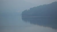 Foggy landscape over the lake 
