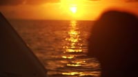 Ocean water and woman's face in the sunset