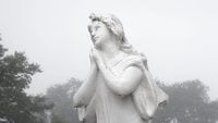 graveyard statue with fog