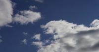 Time lapse of big gray and white clouds moving away from the camera on blue sky in 4K