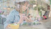 Business freelance Asian woman using smartphone for talking, reading and texting while sitting on table in cafe.