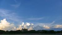 Cloudscape time lapse with farm field
