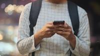 Young man using mobilephone online chat.