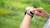Hand touching on screen of smart watch
