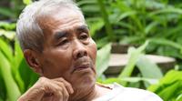 Elderly man talking alone in the park