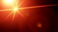 Abstract Optical Vintage Lens Flare burst on black background in 4K