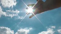 Rayons de soleil qui fuient à travers les doigts du vieil homme