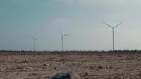 Three Rotating Wind Generators Against The Blue Sky